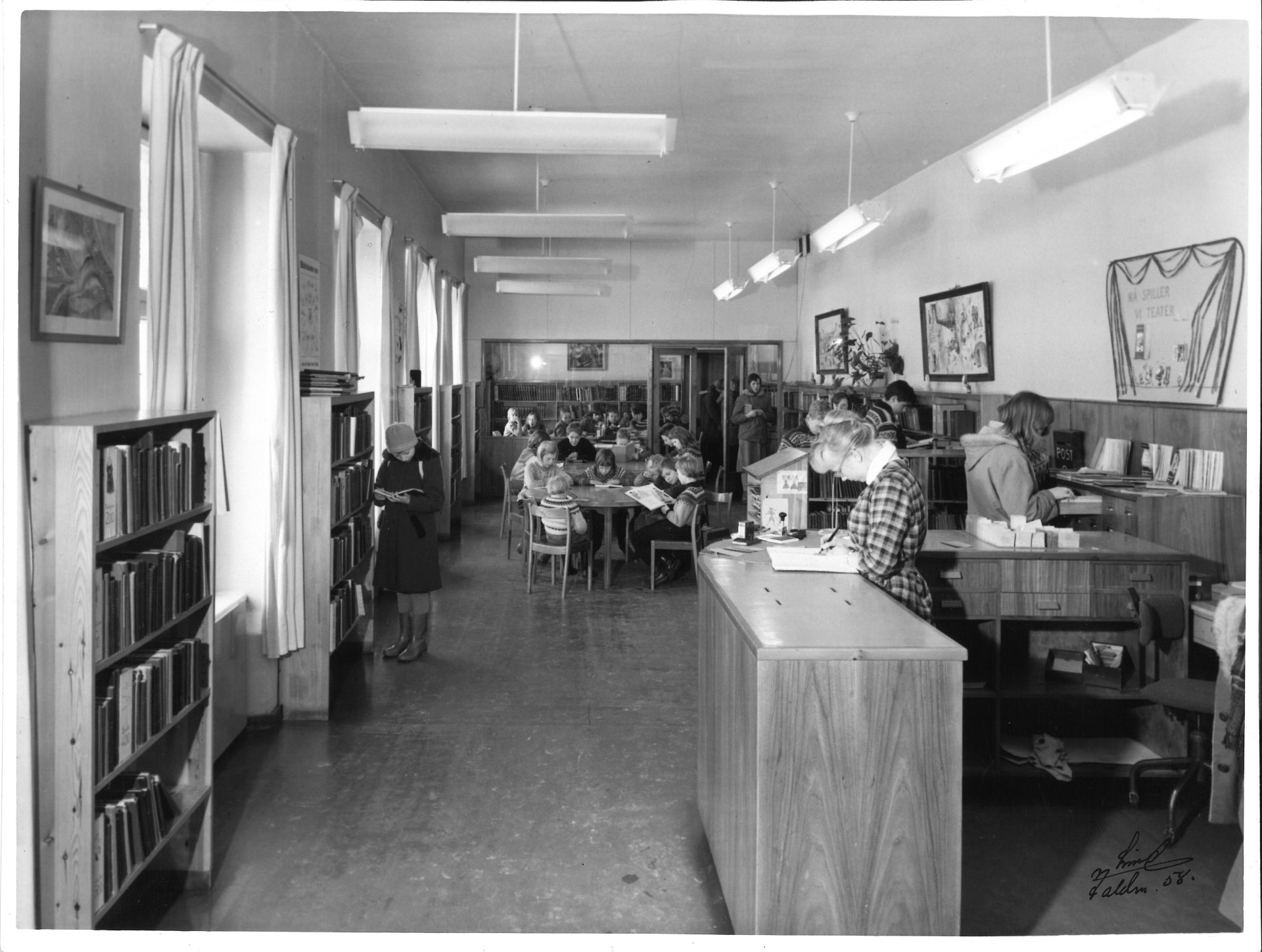 Bilde fra Fayegården hvor biblioteket holdt til tidligere. På bildet ser man rader med bokhyller og en skranke.